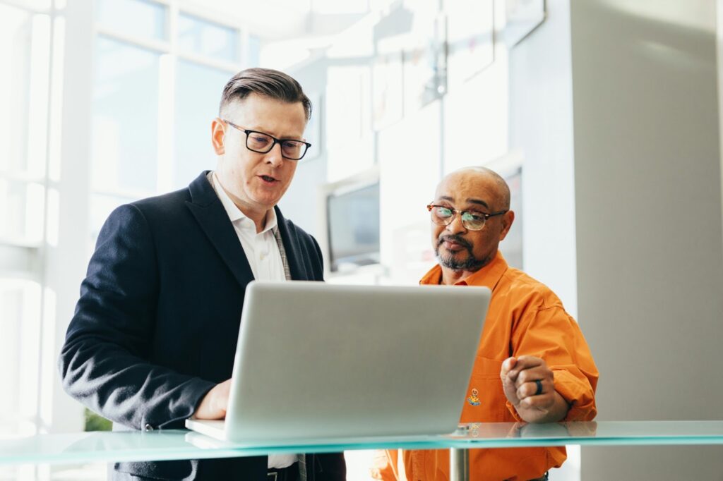 two people at work talking at standing desk