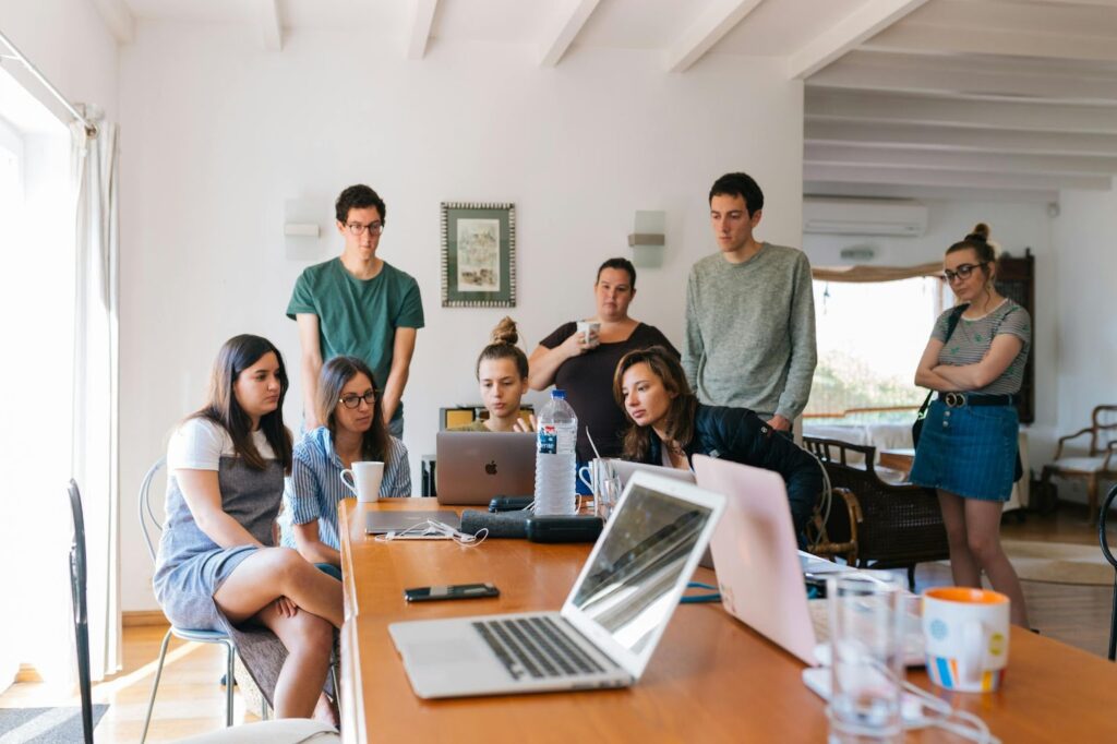 coworkers surrounding a desk