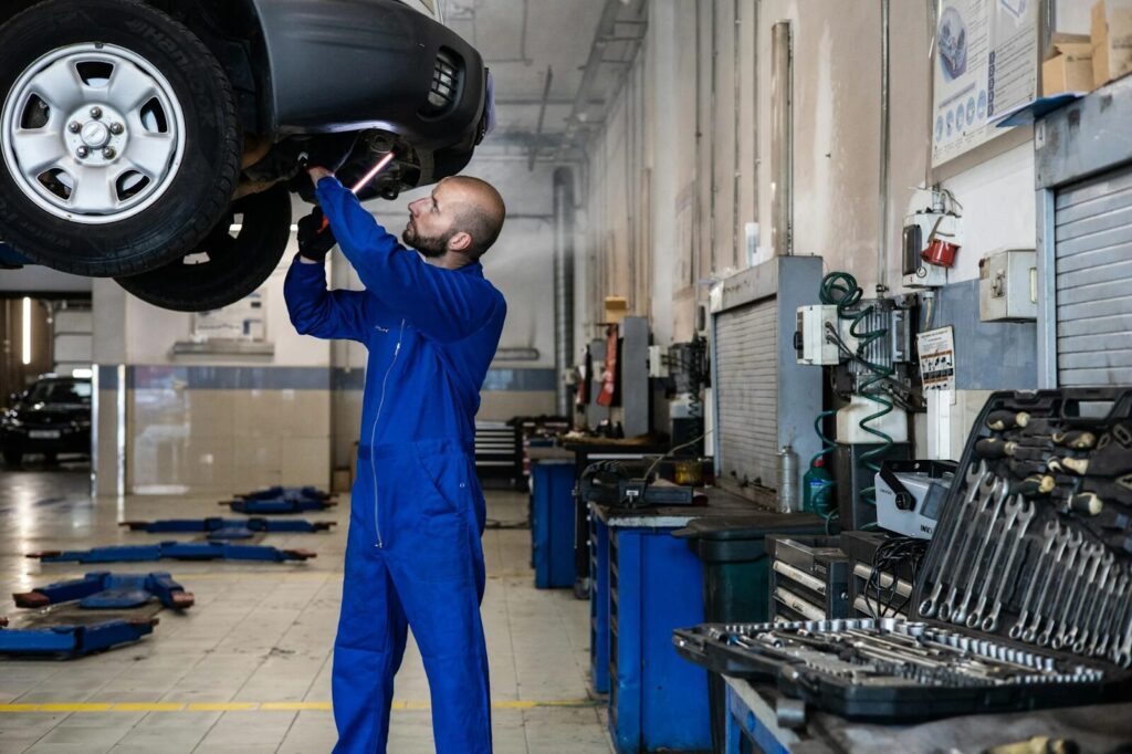 Mechanic working under car